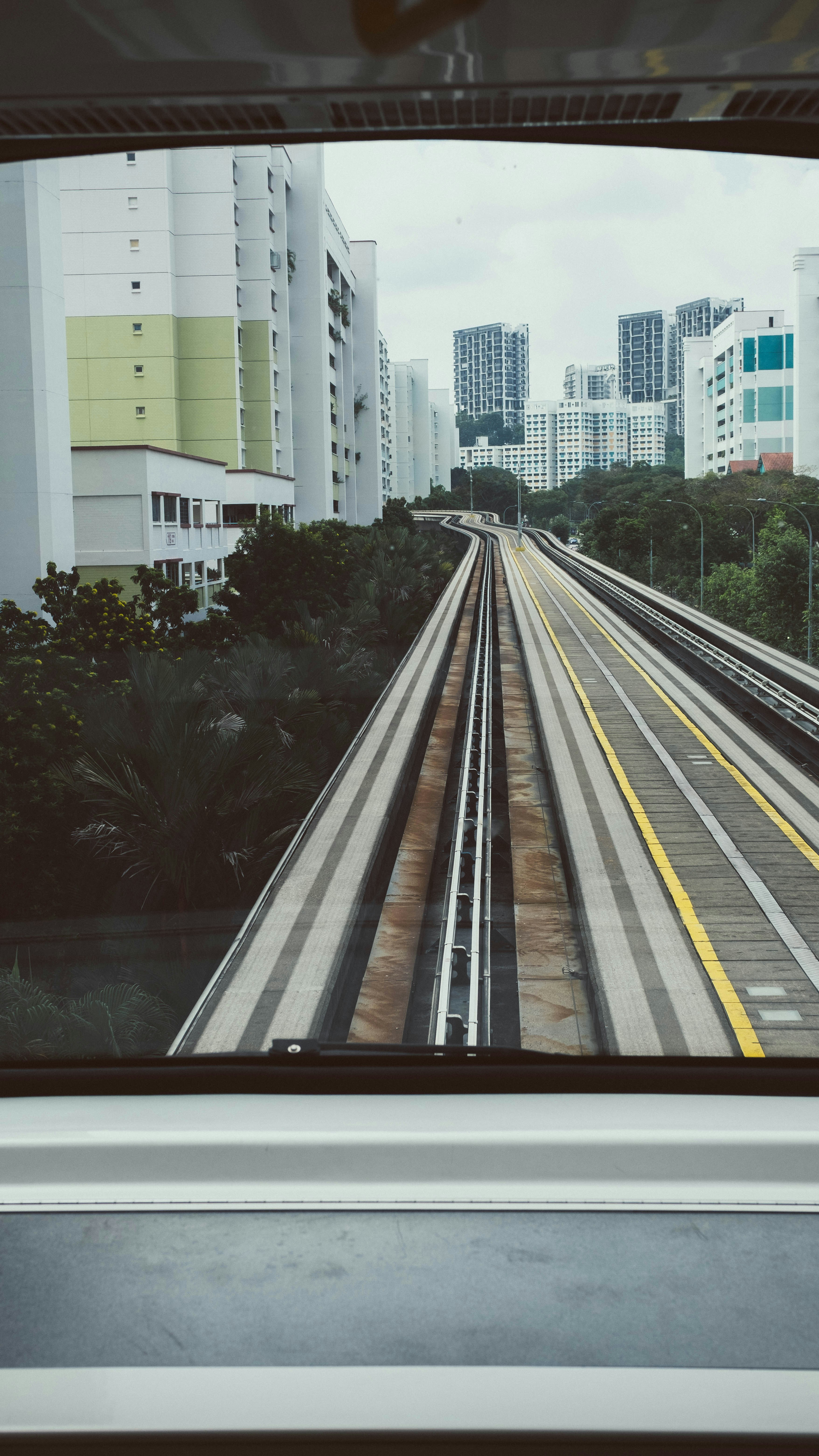 white and gray concrete building near green trees during daytime