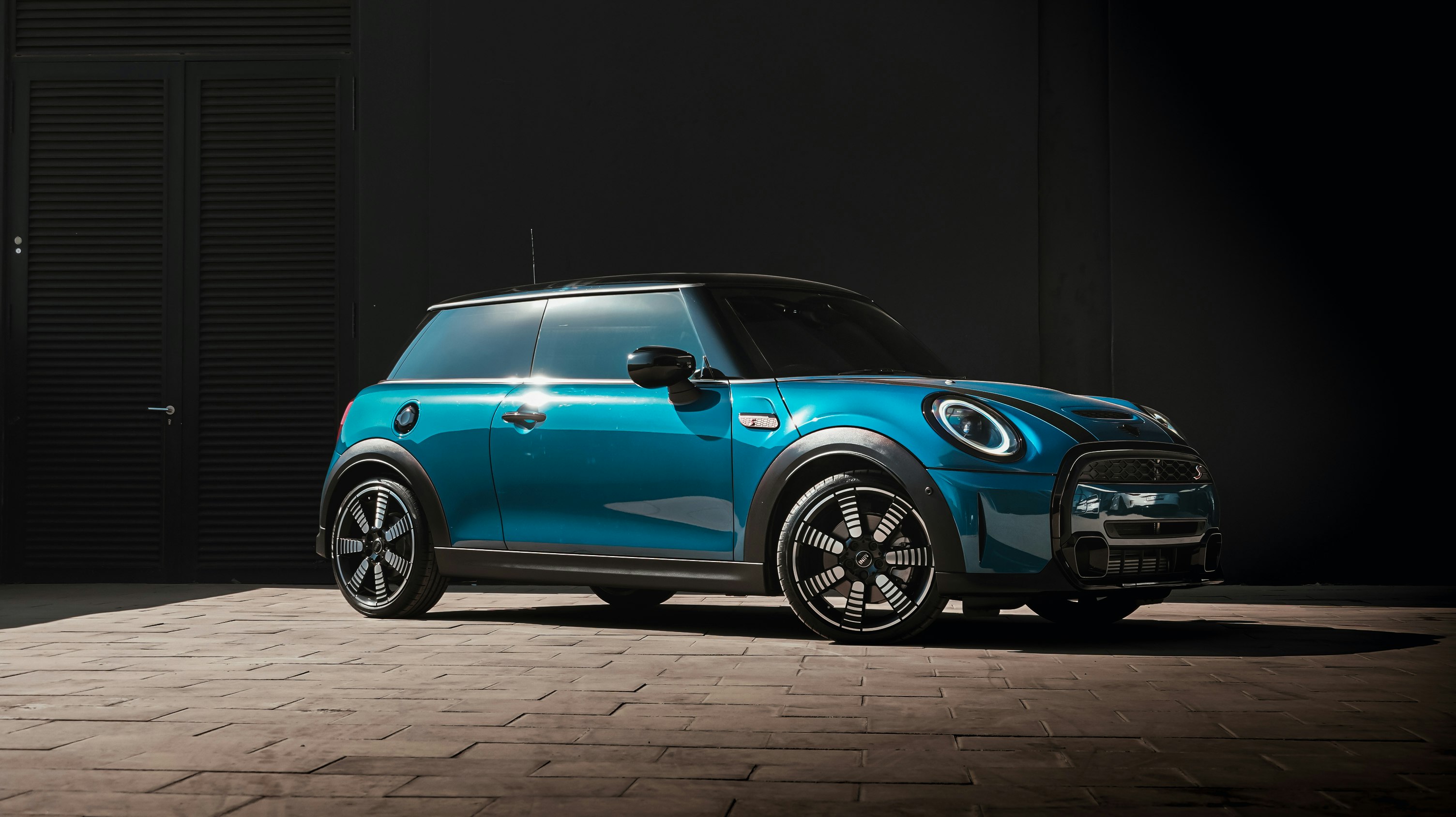 blue volkswagen beetle parked on black background