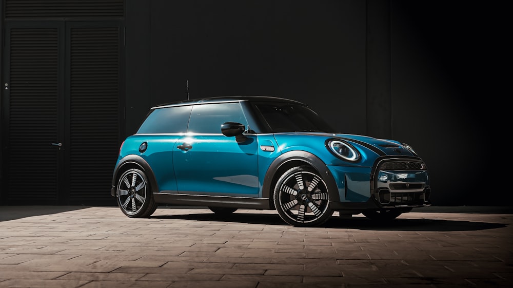 blue volkswagen beetle parked on black background