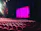 Students practicing acting on stage in a bright, colorful theater classroom.