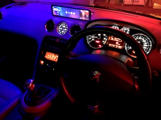 A sporty car dashboard with high-tech accessories and gadgets glowing in electric blue accents.