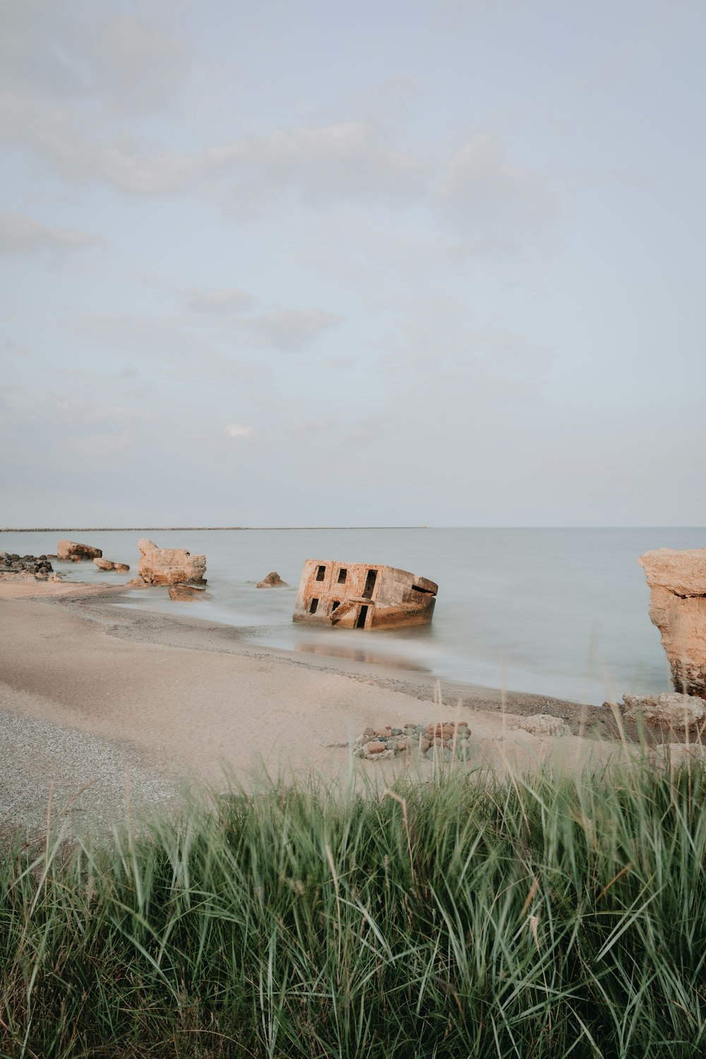 brown rock formation on sea shore during daytime