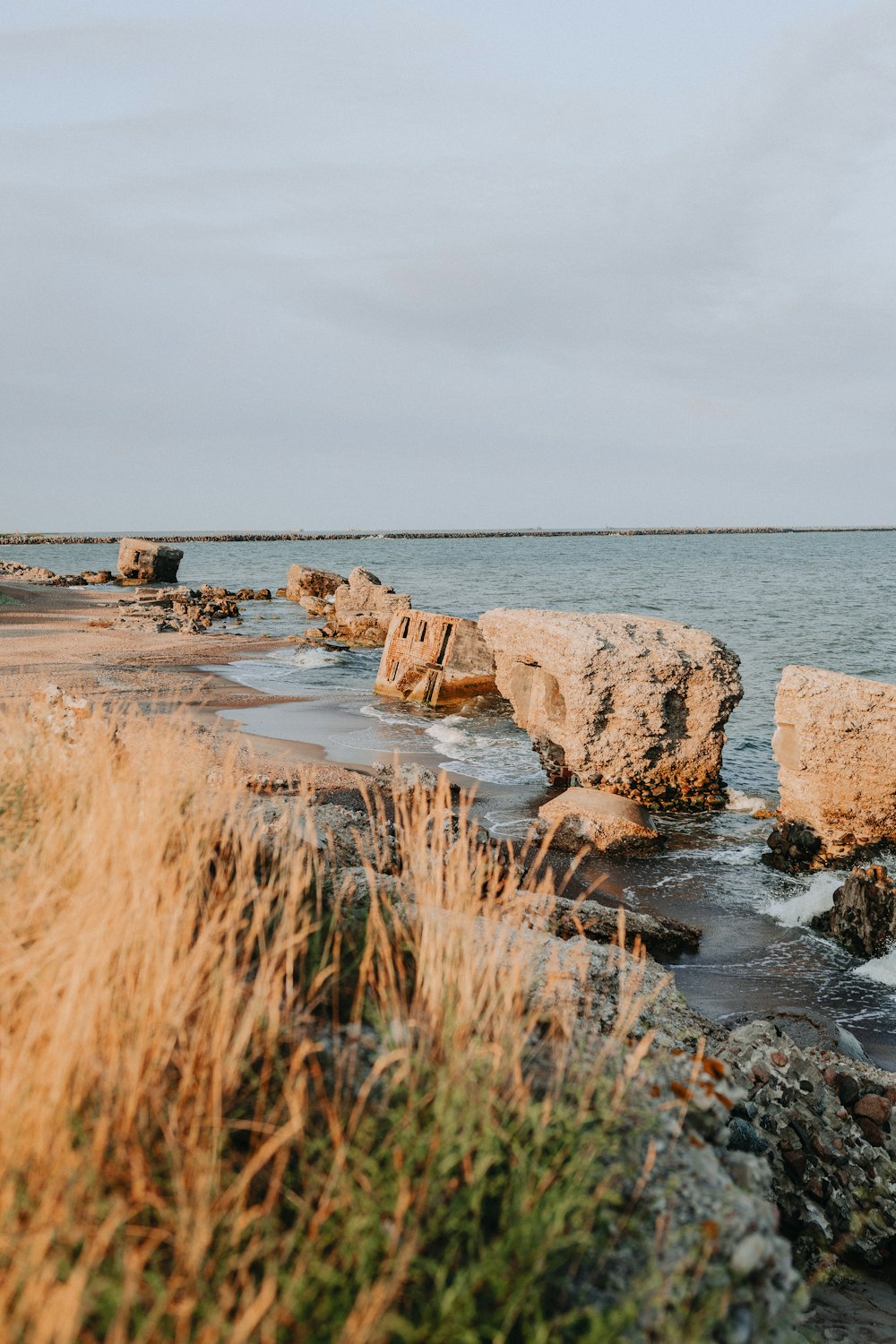 brown rock formation on sea shore during daytime