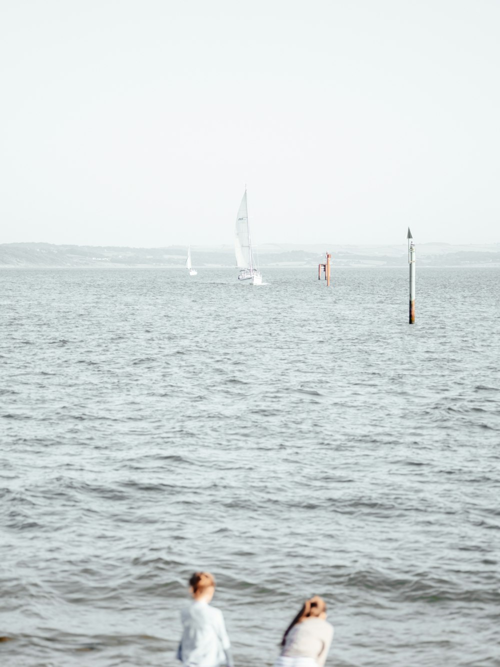 white sail boat on sea during daytime