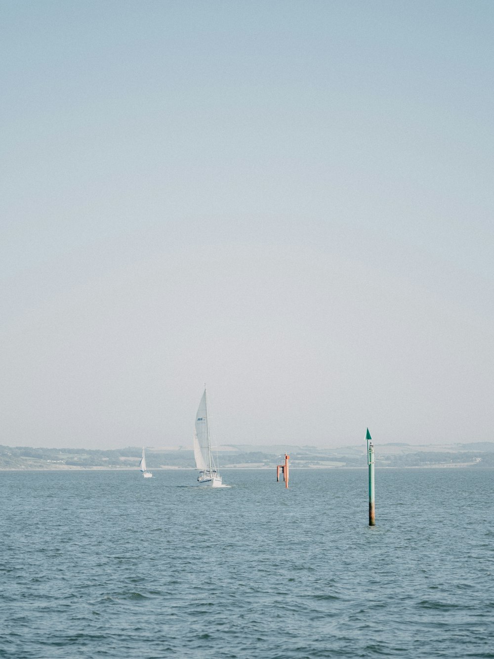 white sail boat on sea during daytime