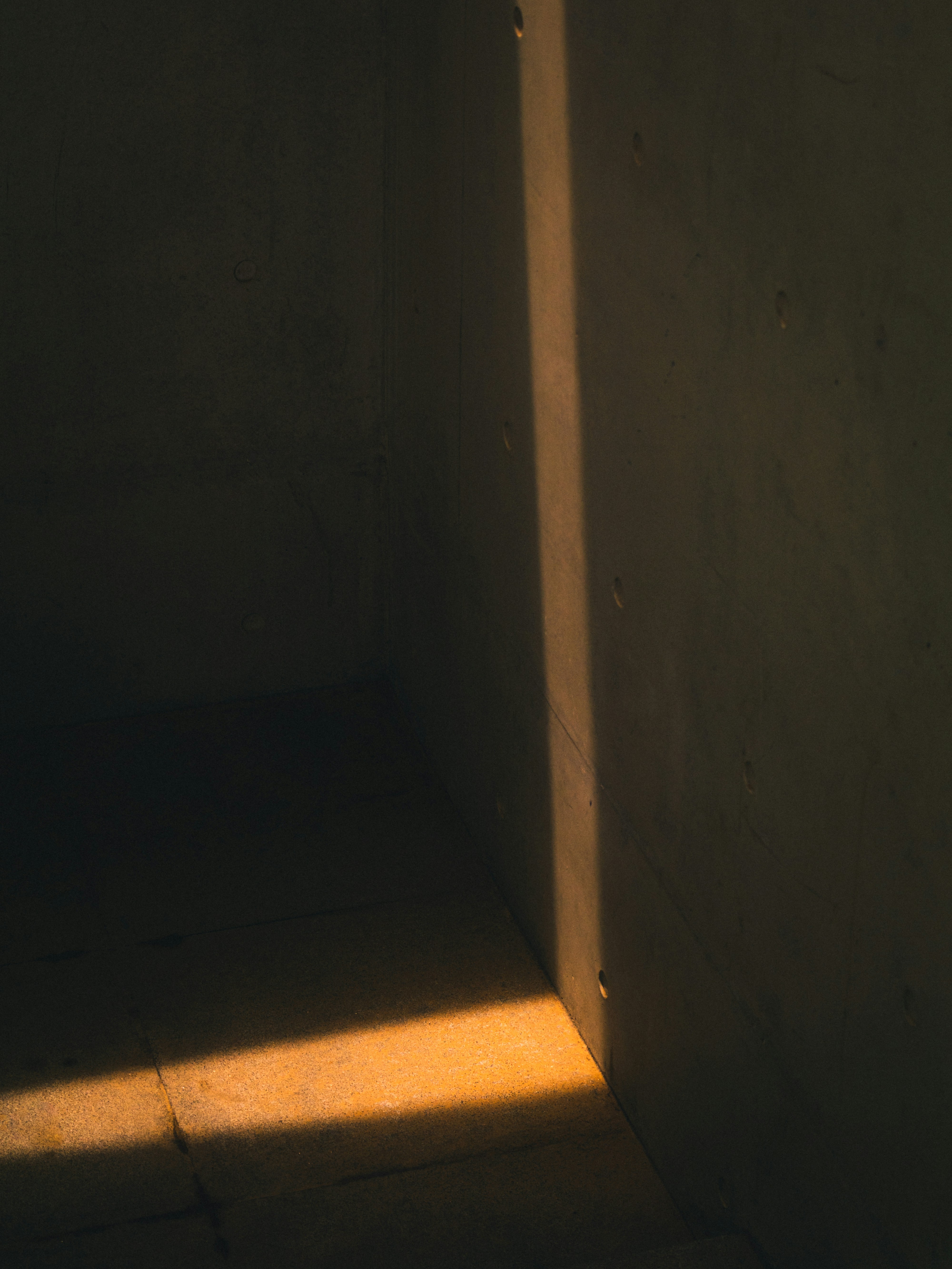 brown concrete wall near brown wooden door