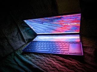 A sleek laptop displaying a dynamic AI-driven website interface with glowing data streams.