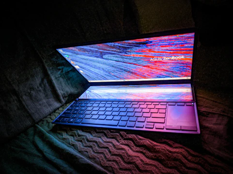 A sleek laptop displaying a dynamic AI-driven website interface with glowing data streams.