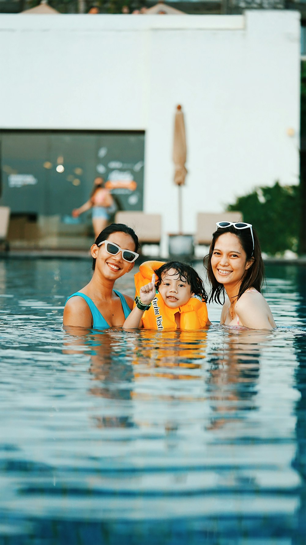 2 women in swimming pool posing for photo