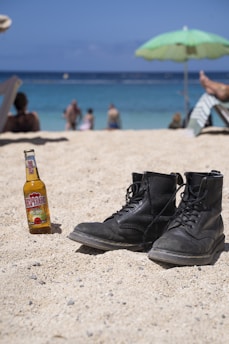 black leather boots on beach