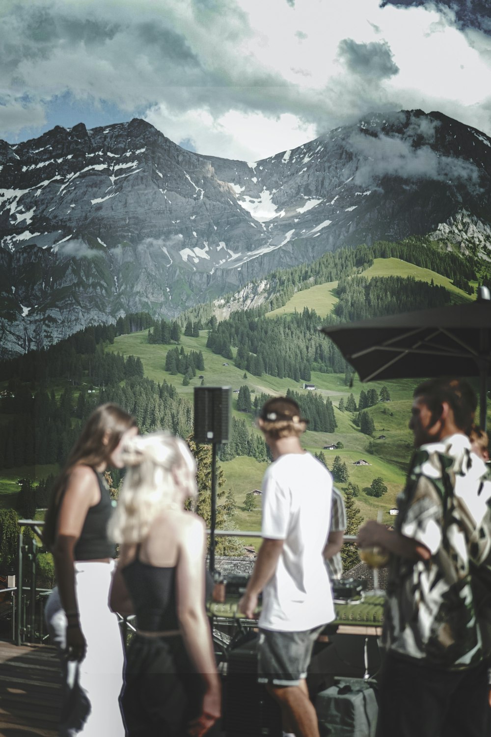 people standing near green mountain during daytime