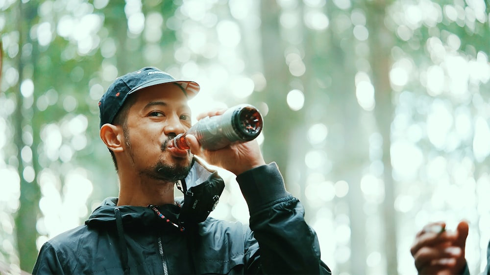 man drinking from a bottle