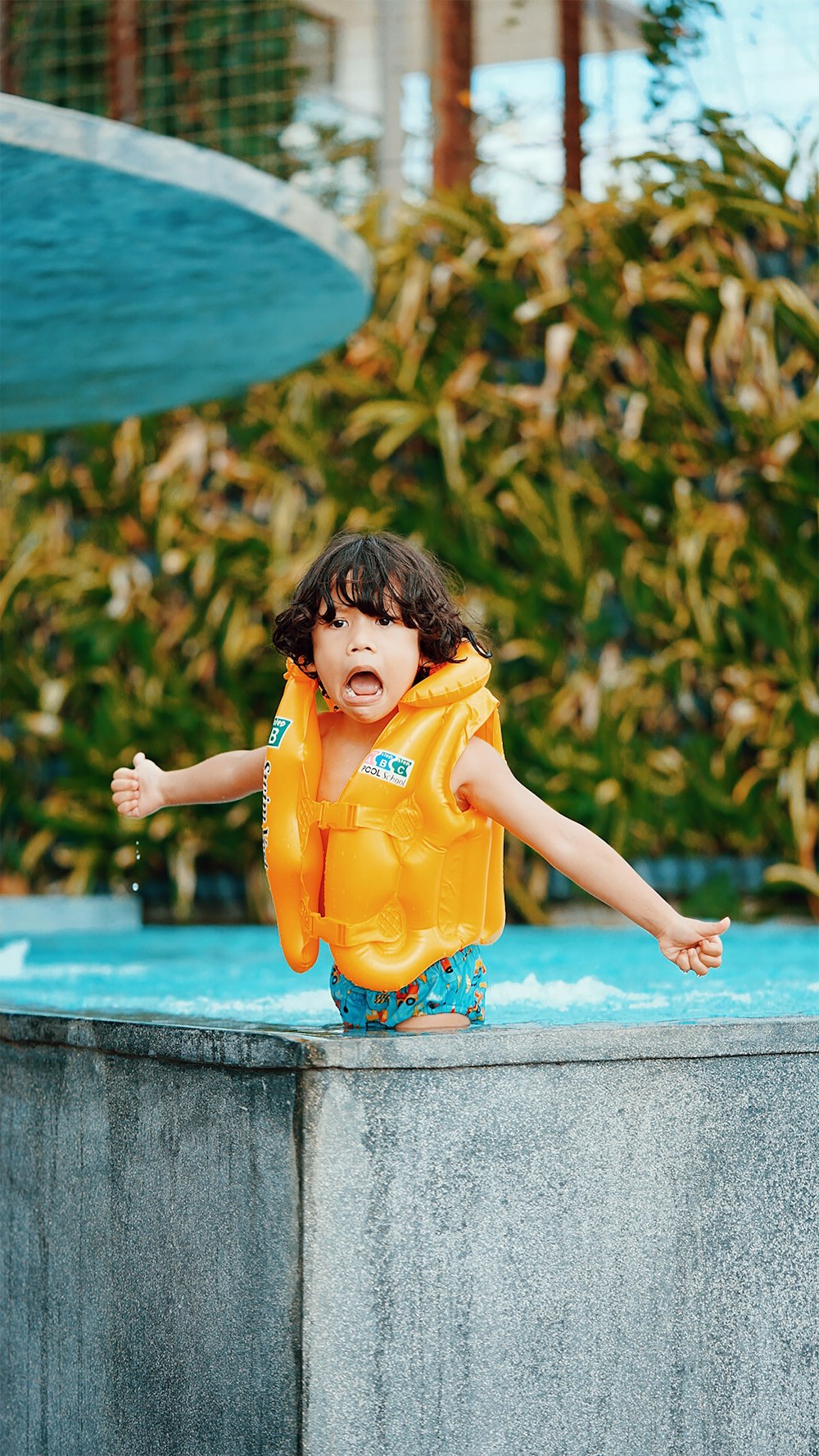 girl in yellow shirt sitting on concrete bench