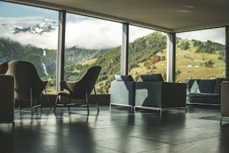 black and white padded chair near glass window