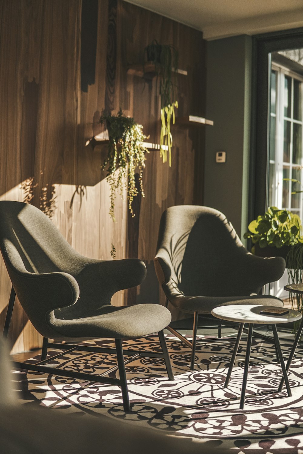 black metal framed white padded armchair beside white round table