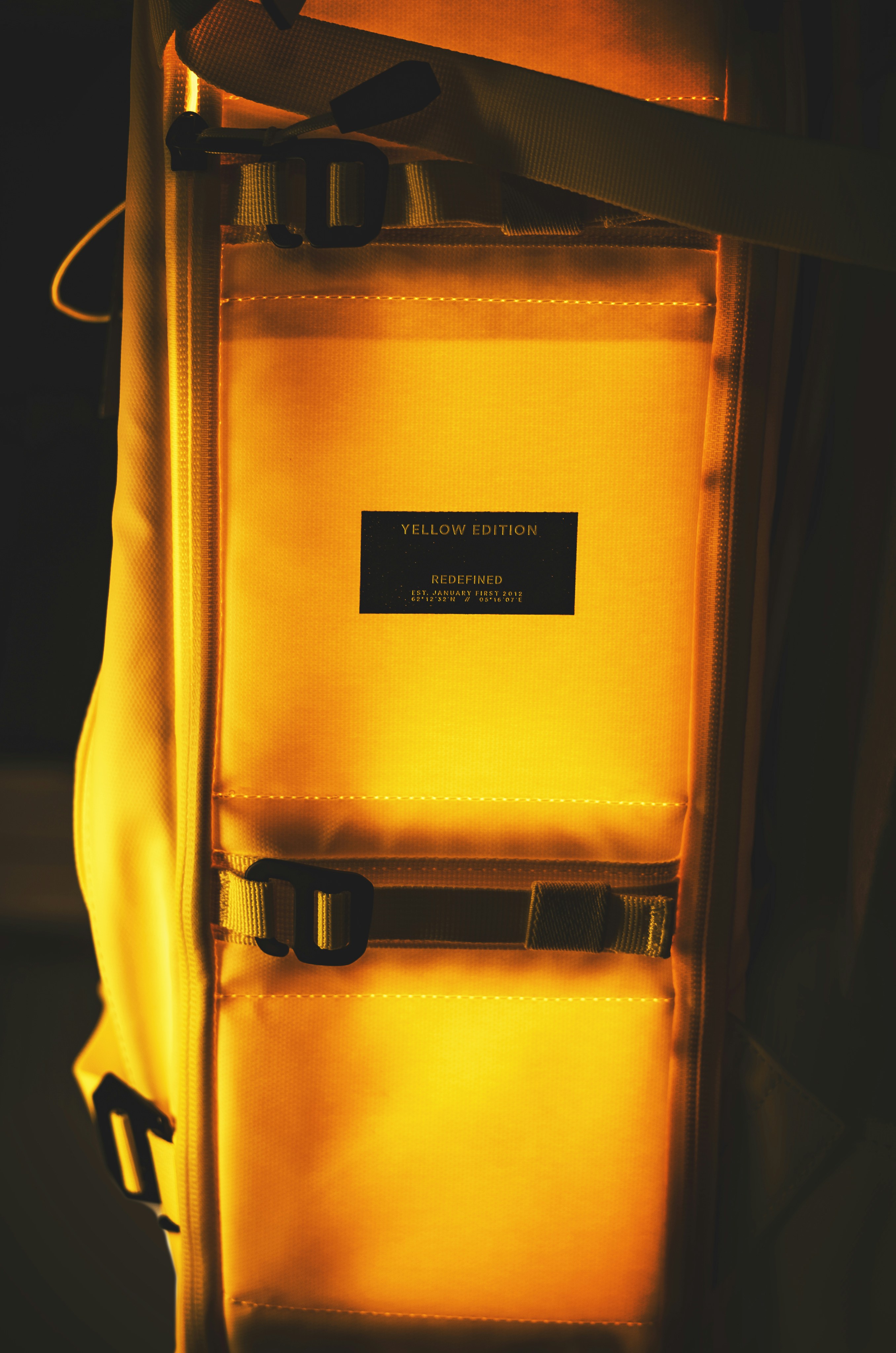 yellow and black bag on black textile photo Free Douchebag Image on
