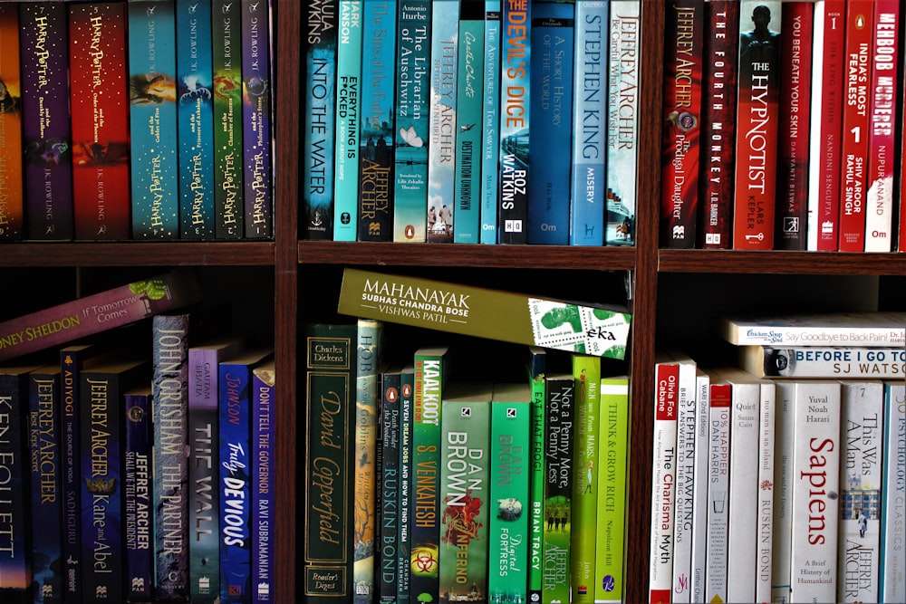 books on brown wooden shelf