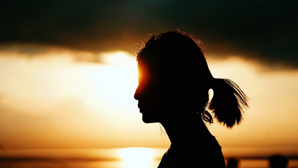 silhouette of woman during sunset