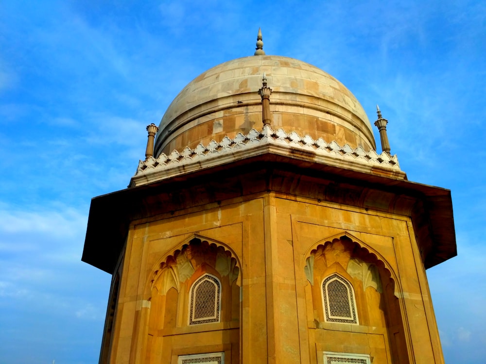 brown concrete dome building under blue sky during daytime