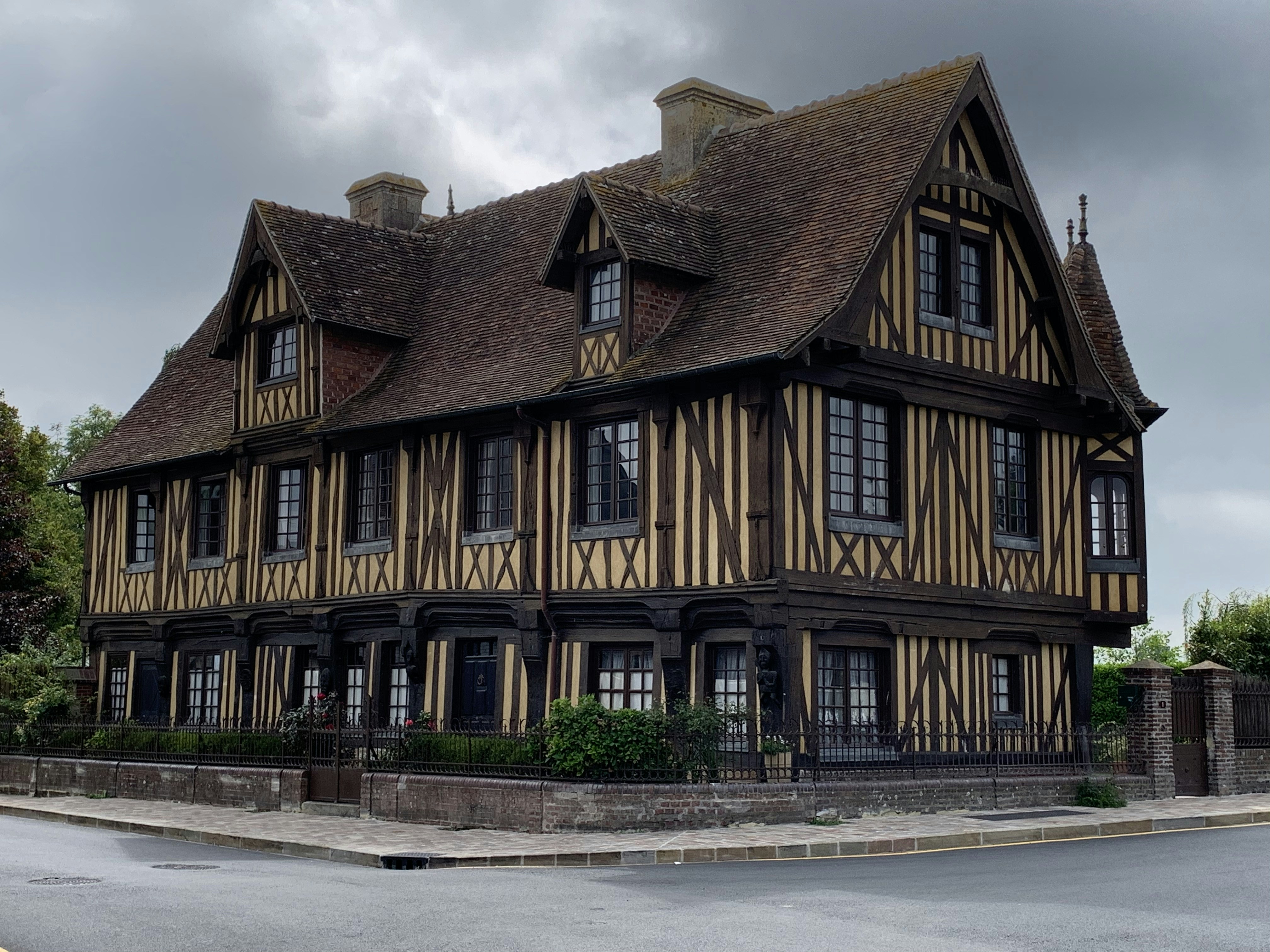 brown and black concrete building under white clouds during daytime