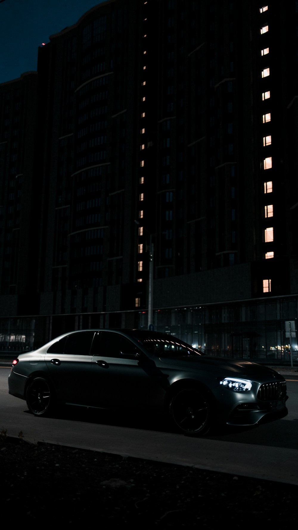 black sedan parked beside building during daytime