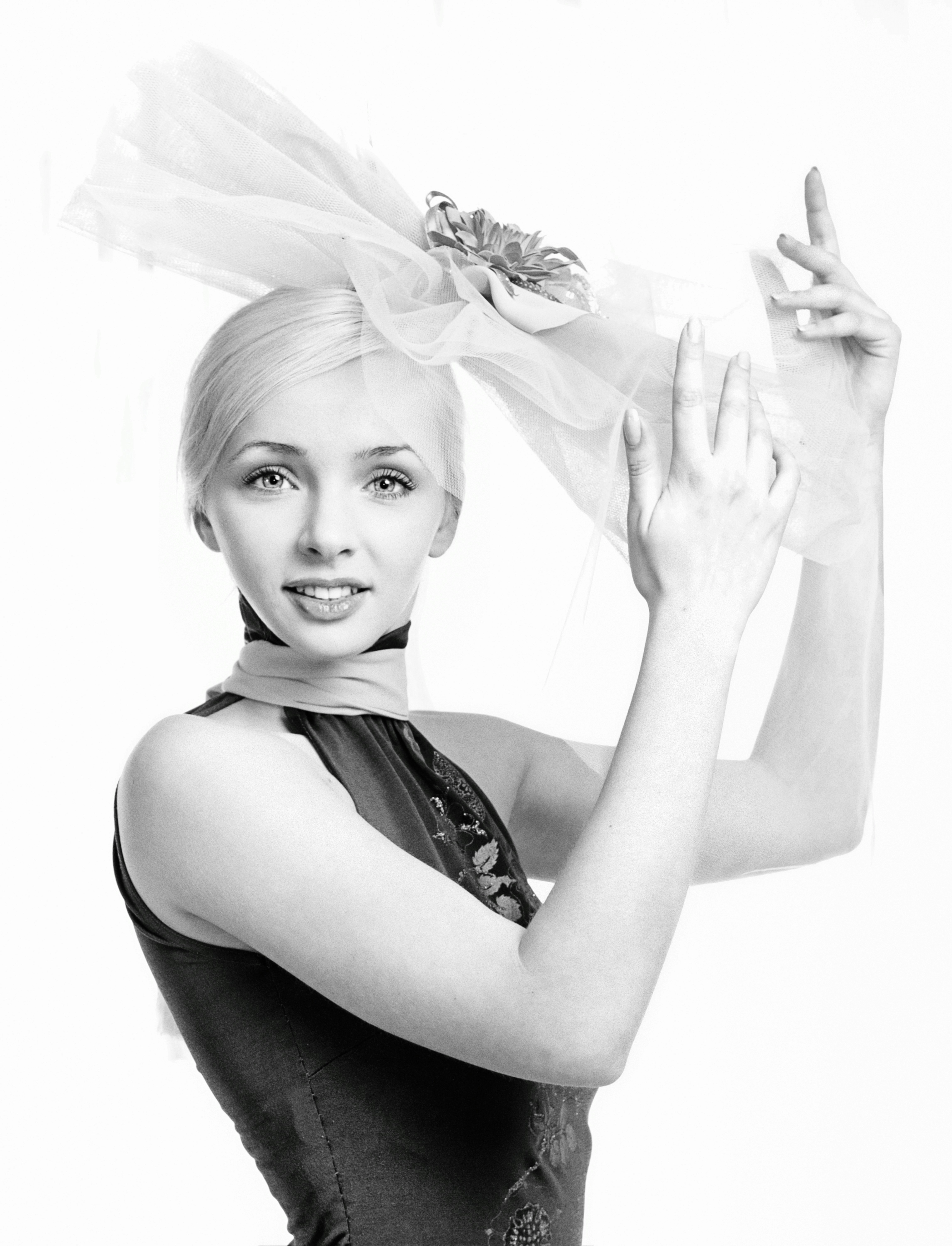 woman in black tank top with white flower on her ear