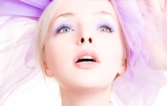 girl in purple shirt with brown hat