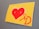 A piece of art featuring a large red heart against a yellow background. Below the heart, there is a stylized red 'MD' monogram with heart motifs incorporated into the letters, all set against a flat surface.