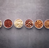 nuts on ceramic bowls-topic-How Much Protein Per Day for Lean