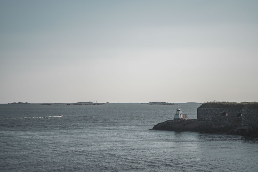 black concrete building on island surrounded by water