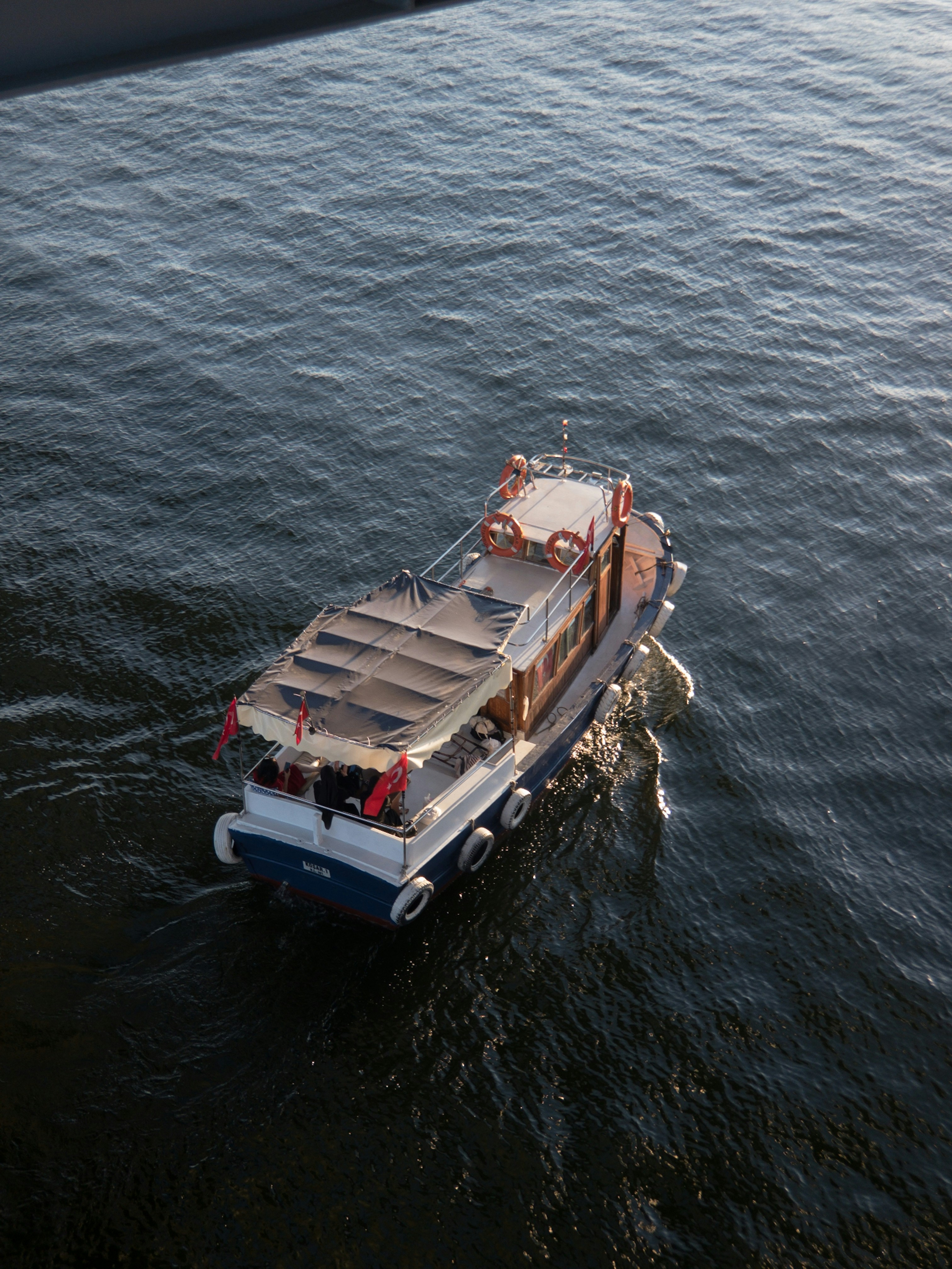 white and brown boat on body of water during daytime