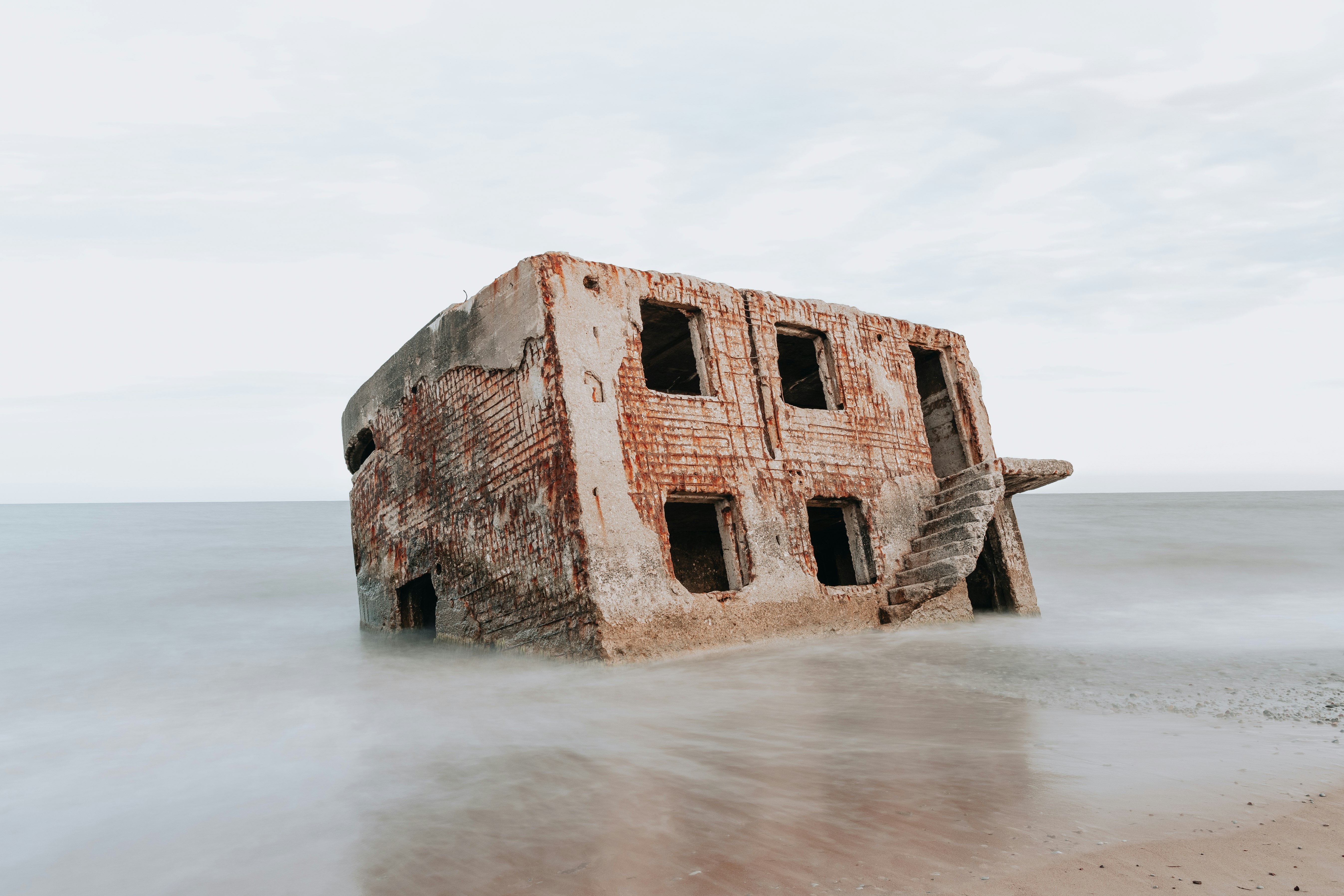 brown concrete building on sea shore during daytime