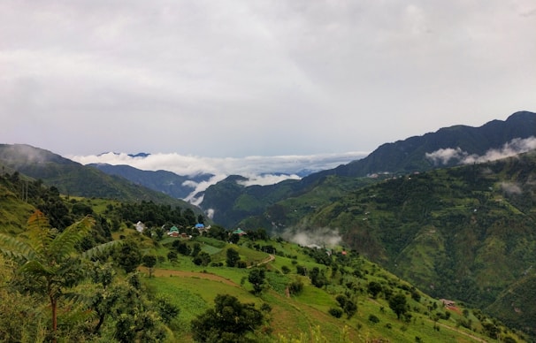 green mountains under white clouds during daytime