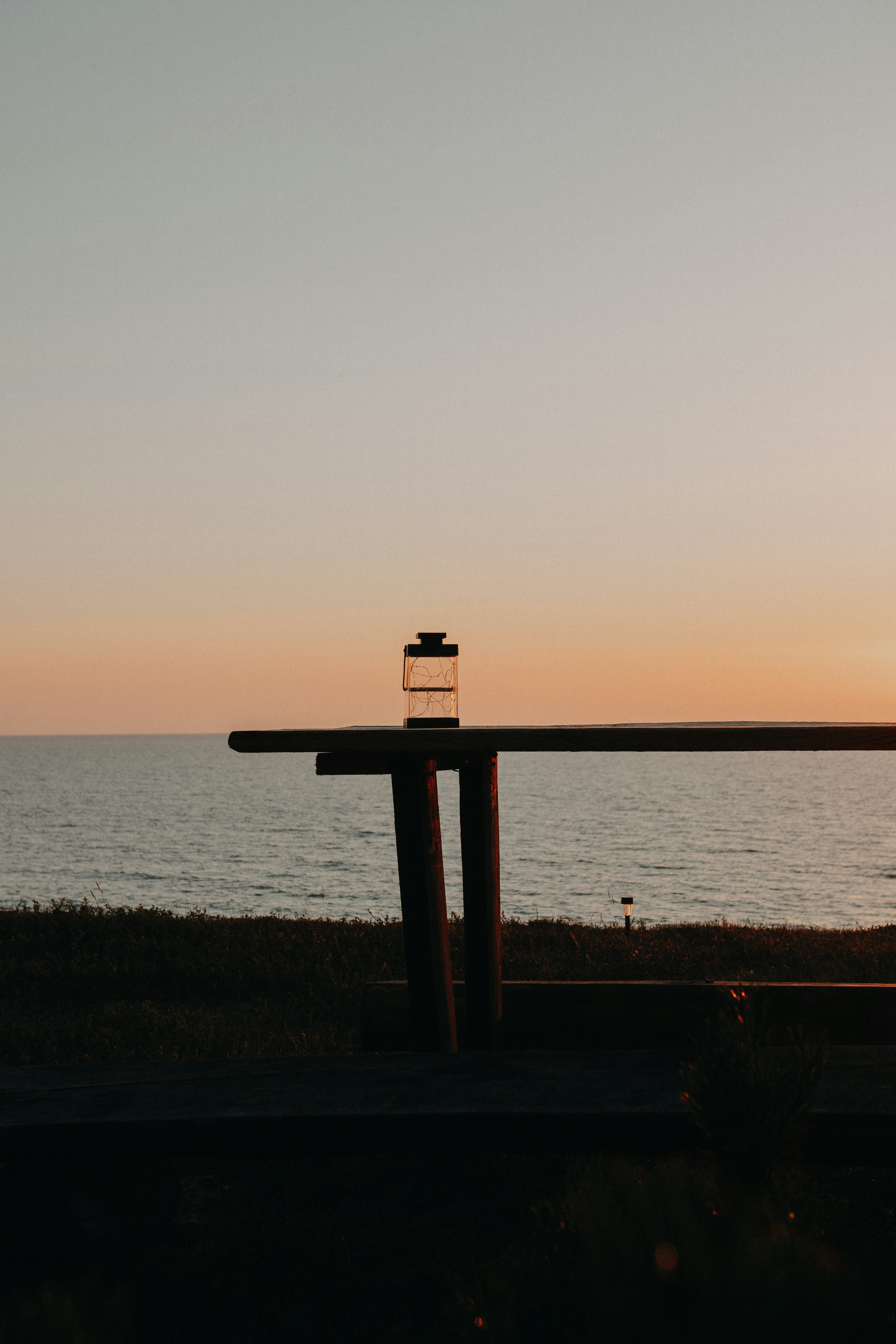 brown wooden post on beach during sunset