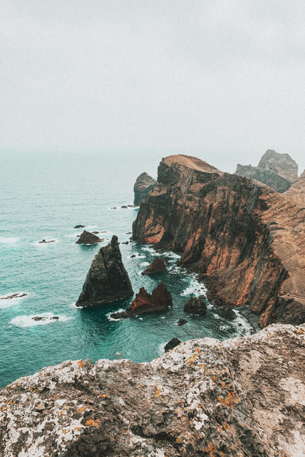 brown rock formation on sea during daytime