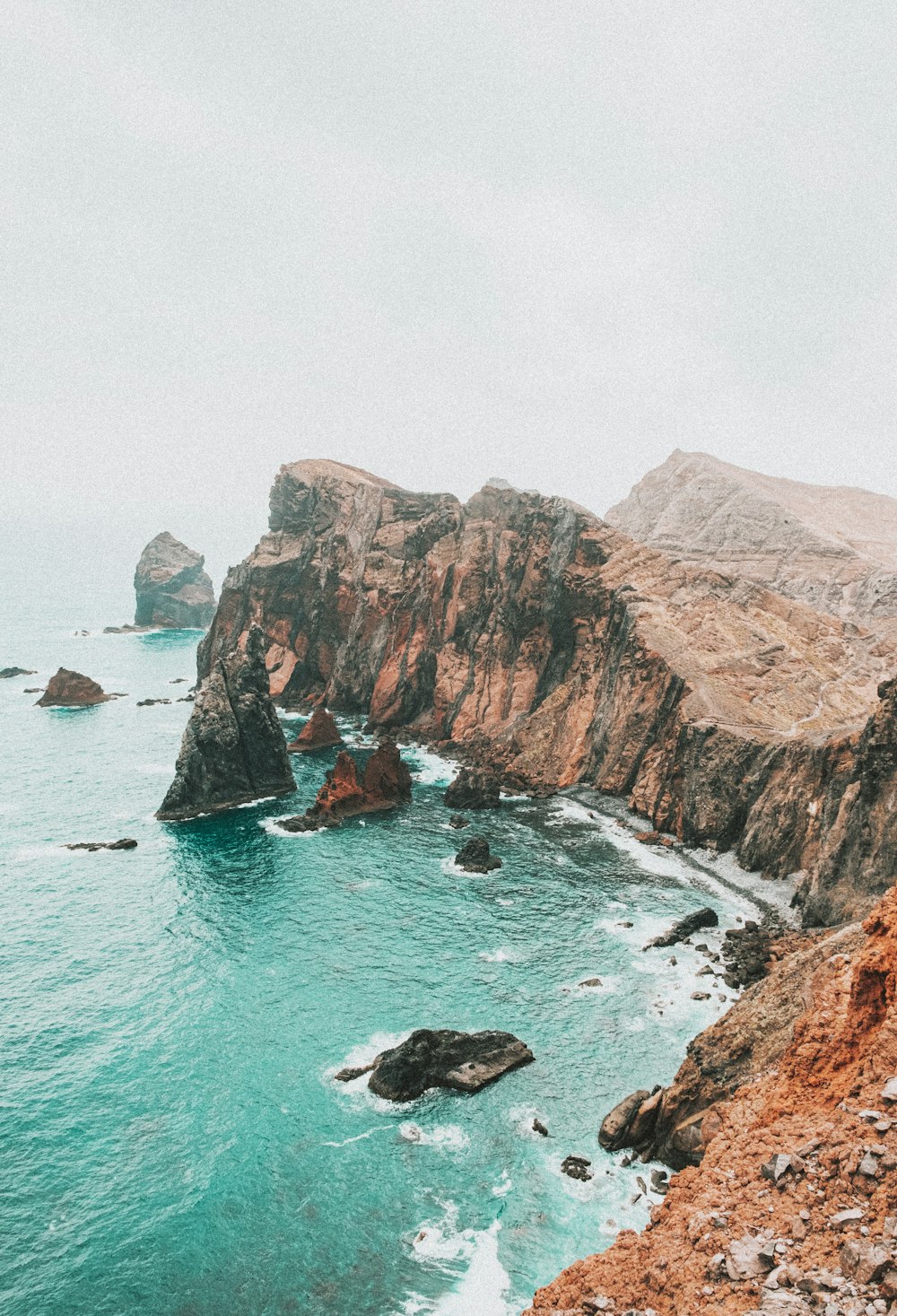 brown rock formation on sea during daytime