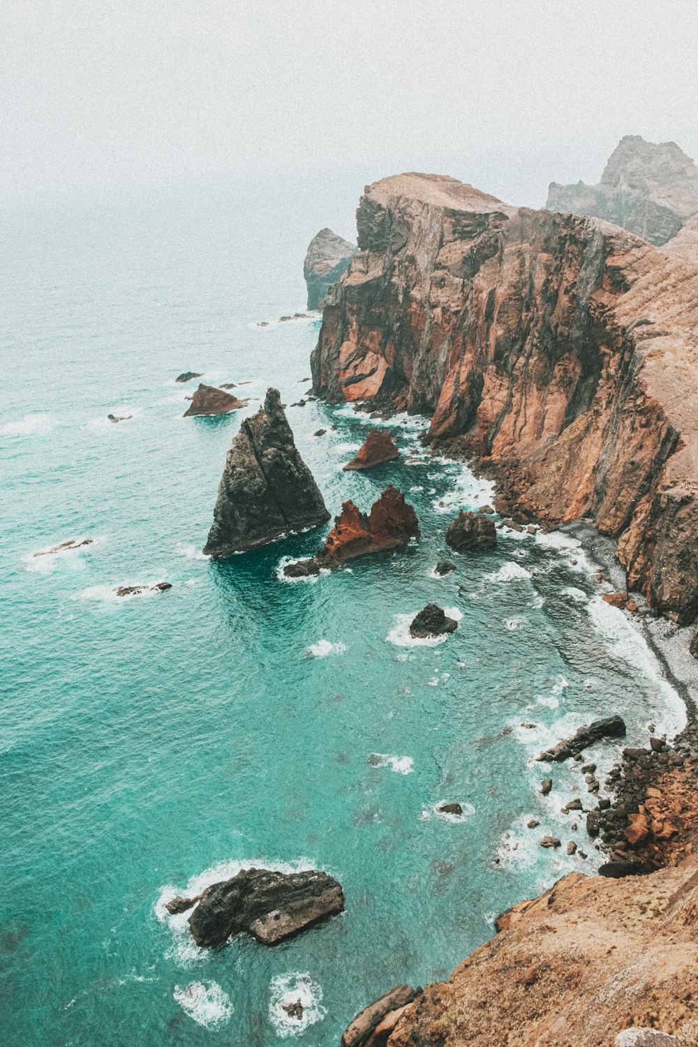 brown rock formation on sea during daytime