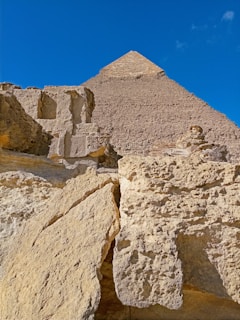 A close-up of an ancient pyramid's weathered stone blocks under a golden sunset.