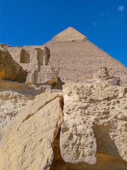 A close-up of an ancient pyramid's weathered stone blocks under a golden sunset.