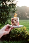person holding sliced of cake