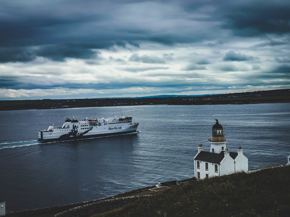 white and black boat on sea during daytime