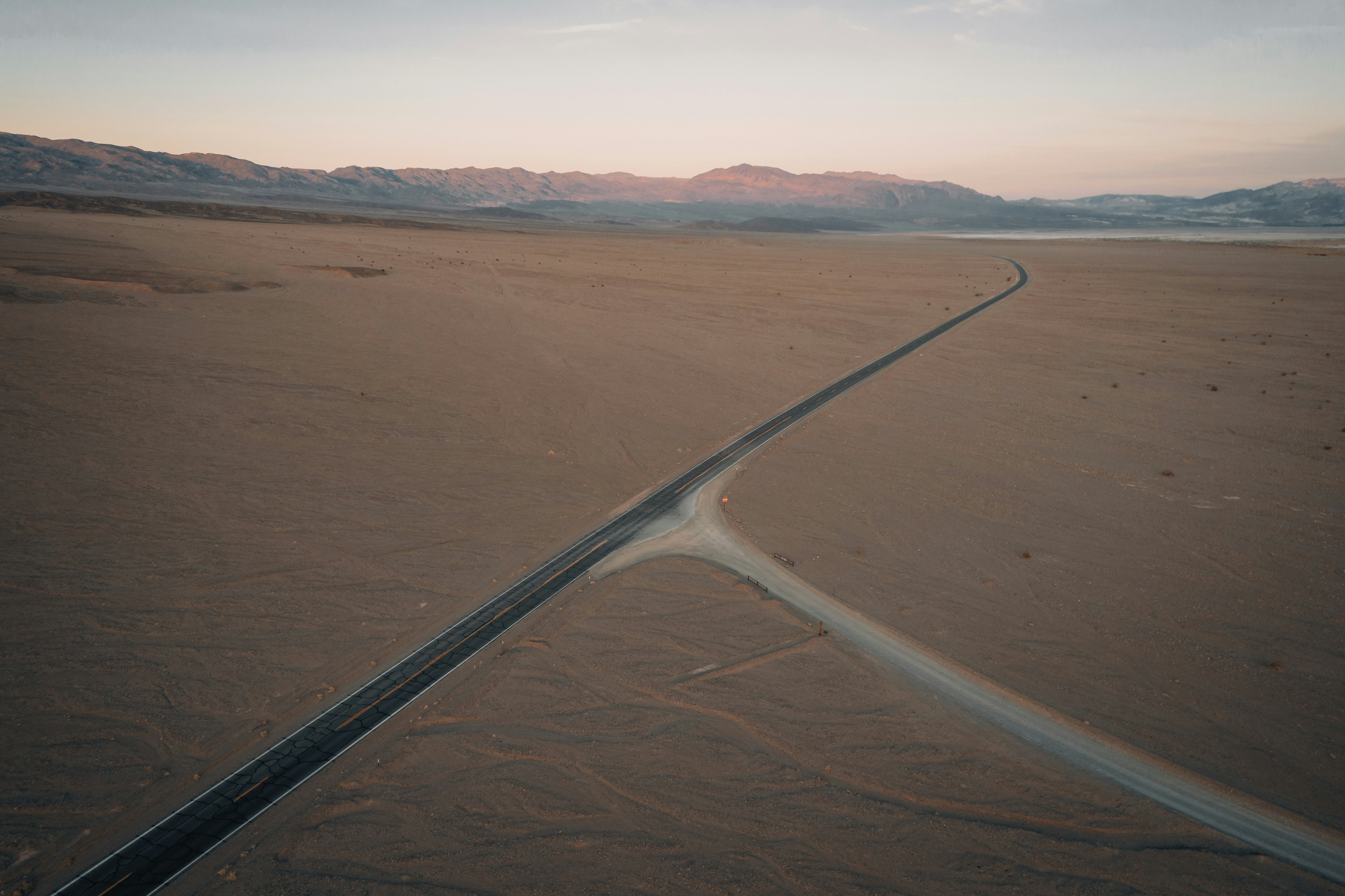 white metal railings on brown sand, Death Valley