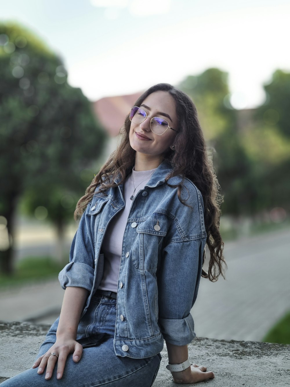 woman in blue denim jacket and black framed eyeglasses