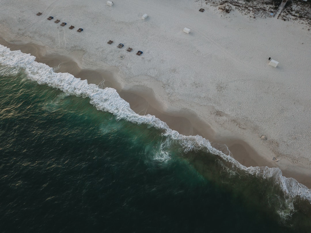 sea waves crashing on shore during daytime