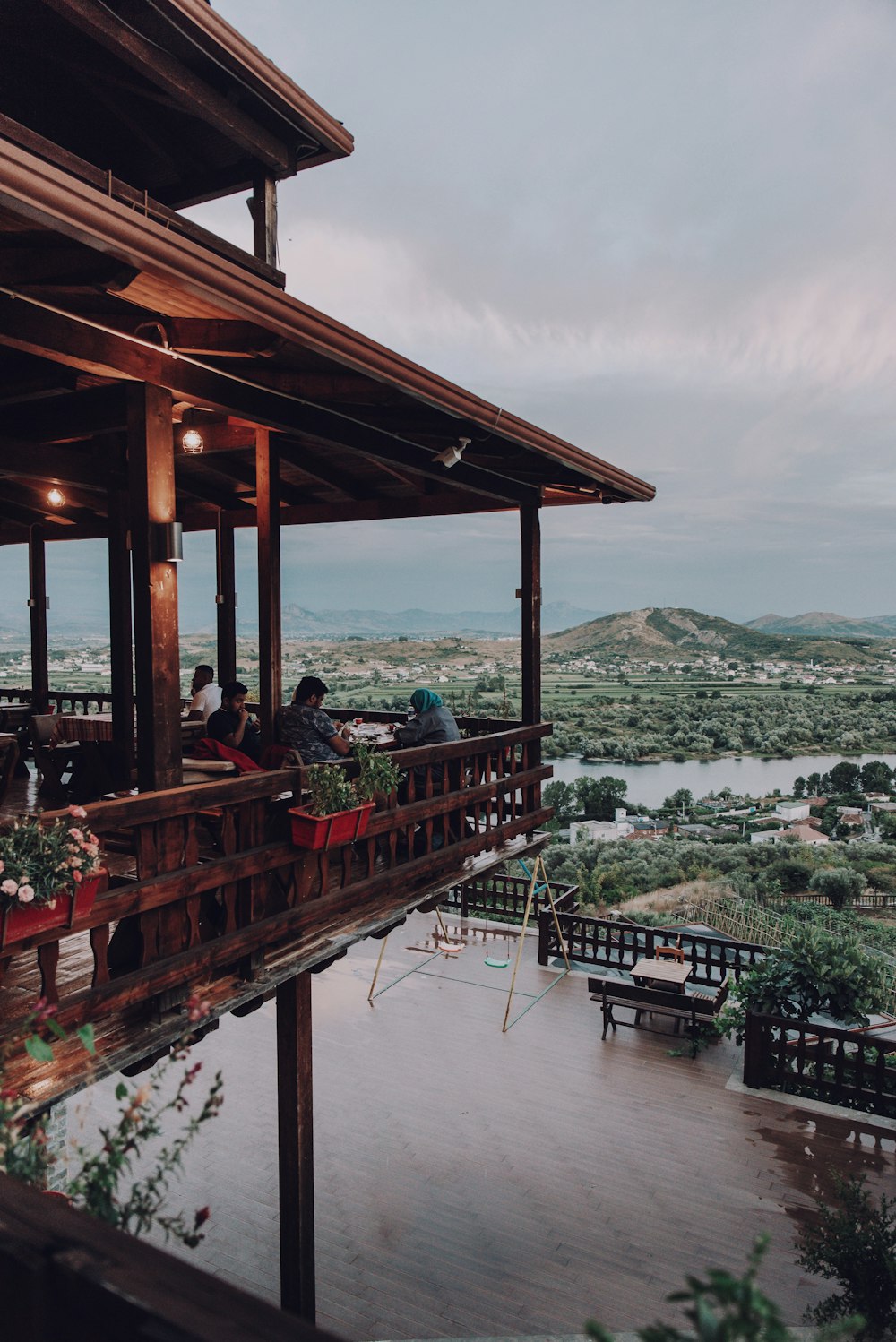 brown wooden gazebo on body of water during daytime