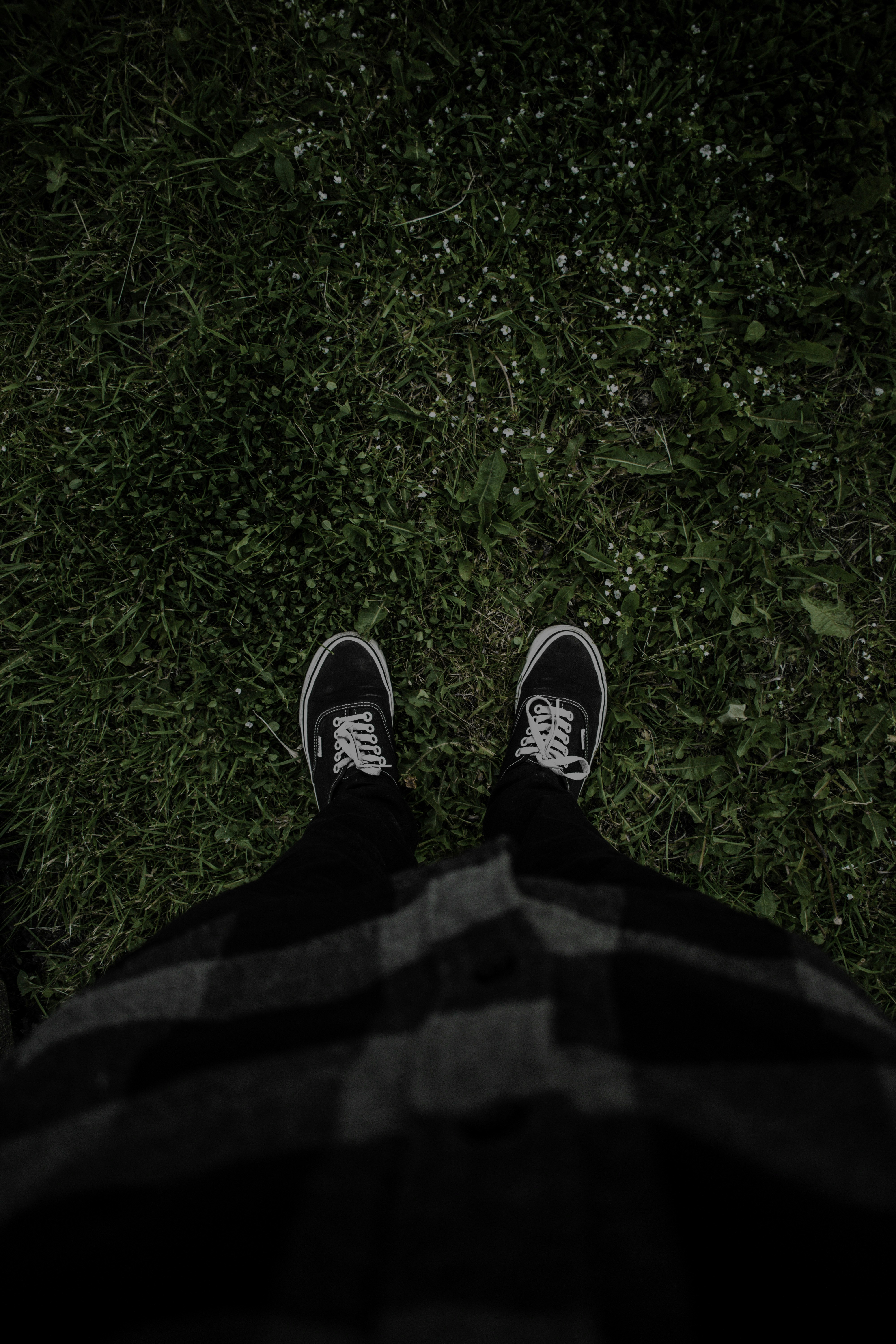 person in black pants and black and white sneakers