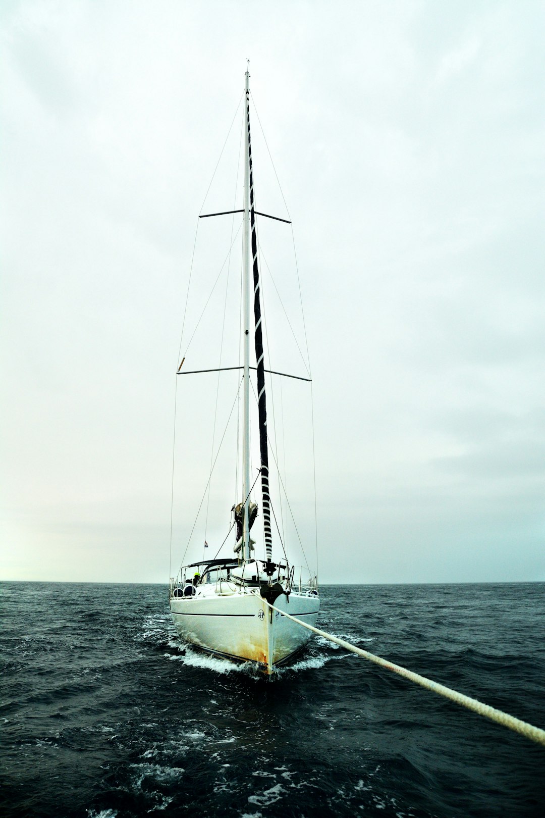 white sail boat on sea during daytime
