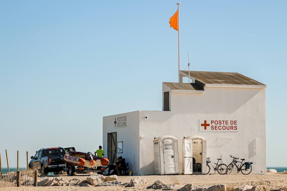 white concrete building with flags on the ground