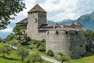 brown brick building on green grass field during daytime  Liechtenstein