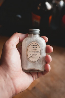 person holding a garlic powder bottle